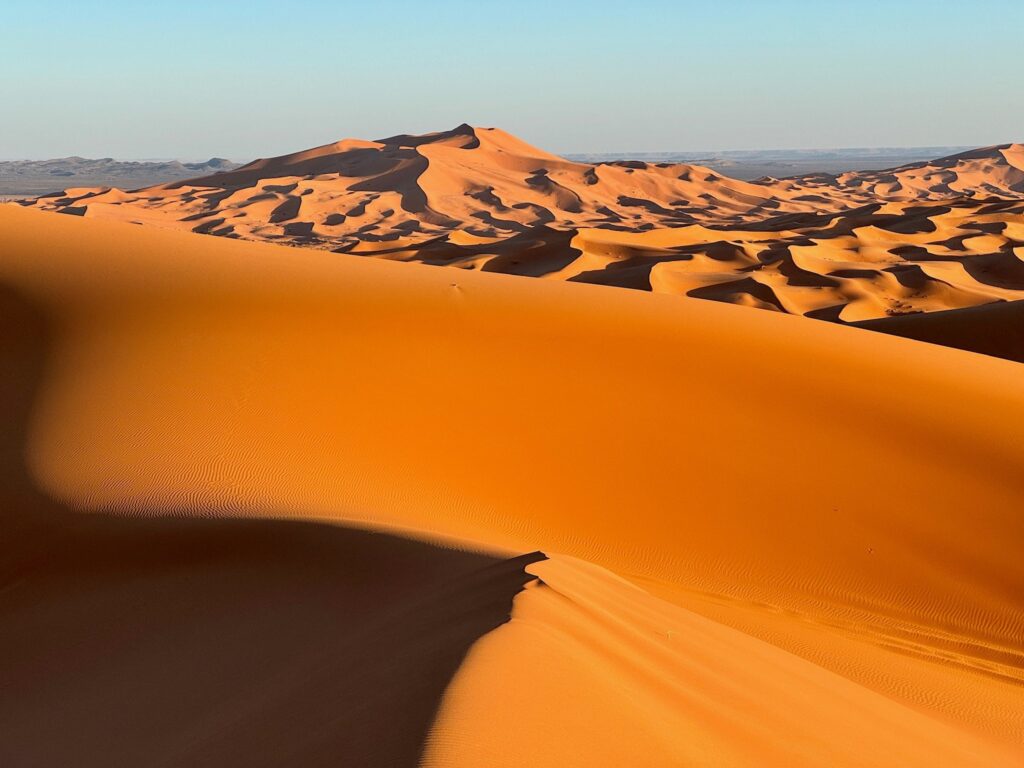 Water gushes through sand dunes after a rare rainfall in Moroccan Sahara desert 