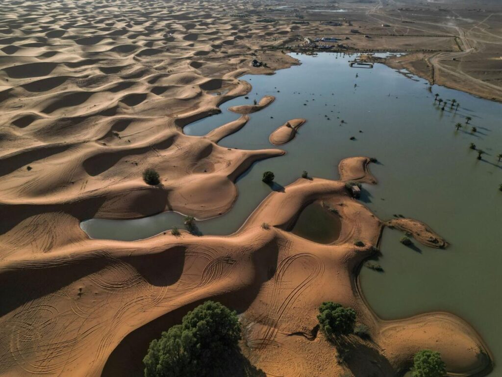 Water gushes through sand dunes after a rare rainfall in Moroccan Sahara desert 